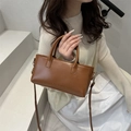Elegant brown leather crossbody bag with FASHION embossing and dual handles - Tan