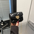 Chic black quilted crossbody flap bag with a golden heart clasp and chain strap - Black