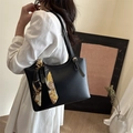 Minimalist black faux leather bucket bag with contrast stitching and floral handle scarf - Black