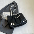 Black tote bag with white bows and heart charms featuring slim white shoulder straps - Black