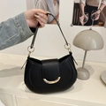 Minimalist black crescent shoulder bag with golden half-moon metal clasp and leather texture - Black