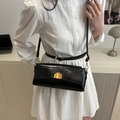 Classic black leather underarm bag featuring a vintage flap and gold semi-circle buckle - Black
