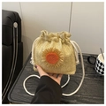 Detailed macro view of straw drawstring bucket bag featuring handcrafted sunflower decor - Khaki with Orange Sunflower