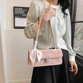 Pink suede shoulder bag with rhinestone buckle and floral scarf on minimalist model - Pink
