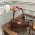 Brown vintage leather bowling bag with dual handles and gold fashion nameplate - Brown