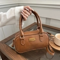Brown vintage style bowling handbag with top handles and a metal logo plaque detail - Brown