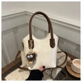 Chic cream bucket bag detail with brown plush monster charm and adjustable strap - With Pendant Style / Off White