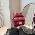 Red quilted mini crossbody bag with a large bow decoration and golden chain strap - Red