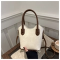 Detail of contrast bucket bag in cream and brown with Fashion & Bags text on desk - Style Without Charm / Off White