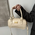 Chic cream-colored handbag with gold hardware and shoulder strap in a stylish minimal pose - Beige