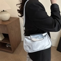 Silver metallic baguette crossbody bag with bow detail worn by model in a stylish setup - Silver