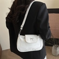 White PU leather crossbody bag with a metal bow accent and adjustable shoulder strap - White