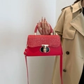 Chic red glitter leather handbag with golden T-buckle and crossbody strap - Red