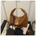 Detail of brown leather dumpling bag with gold COIH metal logo and zipper hardware - Brown (With Charm)