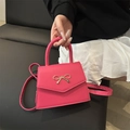 Fuchsia crossbody mini square bag with golden bow hardware and a sleek top handle - Rose Pink
