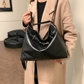 Retro black leather large capacity tote bag with gold metal buckle shown on a model - Black