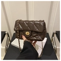 Detailed view of dark brown quilted leather bag with gold twist lock and chain strap - Coffee