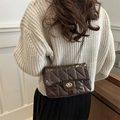 Borsa a tracolla marrone trapuntata con catena dorata su modella con maglione beige - caffè