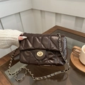 Retro dark brown quilted leather crossbody bag with gold chain strap in life setting - Coffee