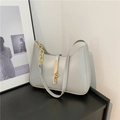 Light grey crescent shoulder bag with glossy finish and bold golden chain detail - Silver