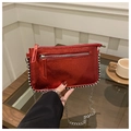 Primer plano de bolso cuadrado rojo metalizado con borde de cuentas y cadena fina - Rojo