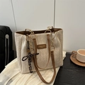 Beige straw woven tote bag with brown leather handles and striped bow pendant - Brown With Pendant