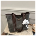 Close-up of grey canvas tote bag with brown leather handles and cloud charm detail - With Pendant / Black