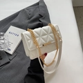 White quilted shoulder bag with gold chain strap and metallic clasp closure - White