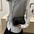 Chic black crossbody bag with silver rivet details and a thin chain shoulder strap - Black