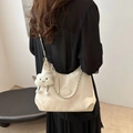 White crescent underarm bag with silver chain and plush cloud charm worn by model - With Cloud Charm / Cream