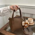 Fashionable brown litchi pattern leather bucket bag with a cute monster plush charm - Coffee with Pendant