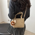 Beige pebble leather bucket bag with monster charm and adjustable strap variant - Khaki (With Pendant)