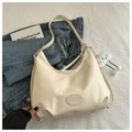 Macro detail of creamy white faux leather hobo bag with fashion logo and cloud charm - No Pendant / White