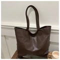 Close-up of fine stitching and rich leather texture on dark brown large tote bag - Coffee