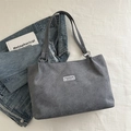 Grey corduroy tote bag with dual shoulder straps and a central minimalist fashion label - Gray