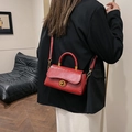 Vintage red oil wax leather crossbody bag with gold buckle shown on a model's back - Red (No Pendant)