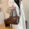 Vintage dark brown crossbody tote bag with golden triangle metal accent and leather texture - Coffee without Pendant