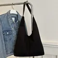 Large vintage matte black tote bag with leather straps on display for daily commute - Black