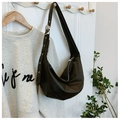 Detail of black hobo bag with wide adjustable strap and silver metal grommets - Black