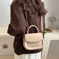 Chic beige matte leather saddle bag with rounded handle and FASHION logo detail - Khaki