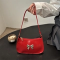 Red glossy faux leather underarm bag featuring a silver bow accent and minimalist design - Red