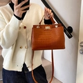 Brown crocodile pattern handbag with gold clasp and ring handle for elegant styling - Brown