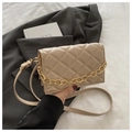 Detail of quilted leather mini bag featuring gold chunky chain and adjustable strap - Khaki