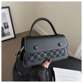 Detail of black crossbody bag featuring grey plaid texture and dual decorative buckles - Black