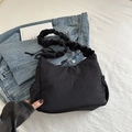 Minimalist black ruched nylon shoulder bag with wide pleated strap and side string detail - Black