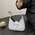 White faux leather crescent bag with black geometric patterns and gold bow buckle - White