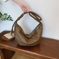 Large dark brown soft PU leather hobo bag with crescent design on a wooden bench - Brown