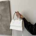 Minimalist small white leather handbag for women featuring a top handle and metal hardware - White