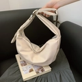 Chic off-white crescent underarm bag with adjustable silver buckle strap and matte finish - Beige