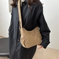 Minimalist nylon drawstring cloud bag in khaki with wide shoulder strap on model - Khaki